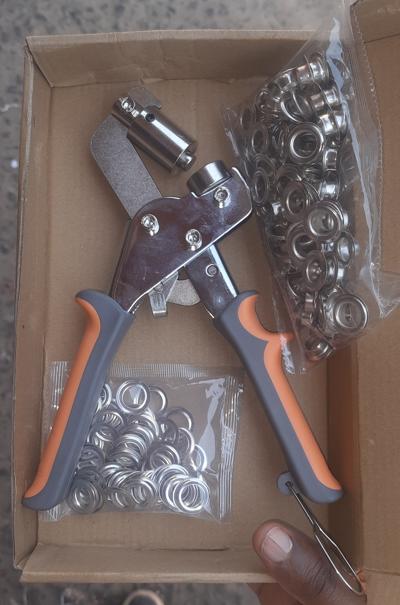 Handheld grommet eyelet plier, a manual press tool used for punching holes and setting metal eyelets into various materials